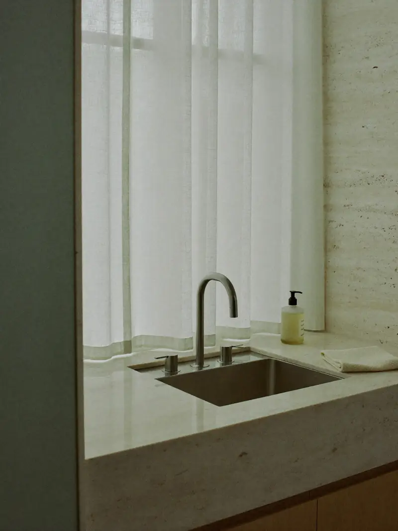 Brushed steel tap and stone basin